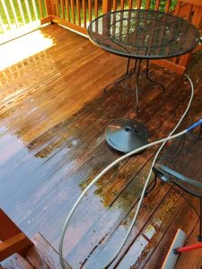 cleaning a deck with a soft wash system